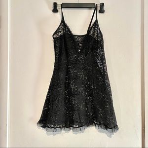 Sexy black lace slip, thigh-high lace-top stockings & red halter style bralet.